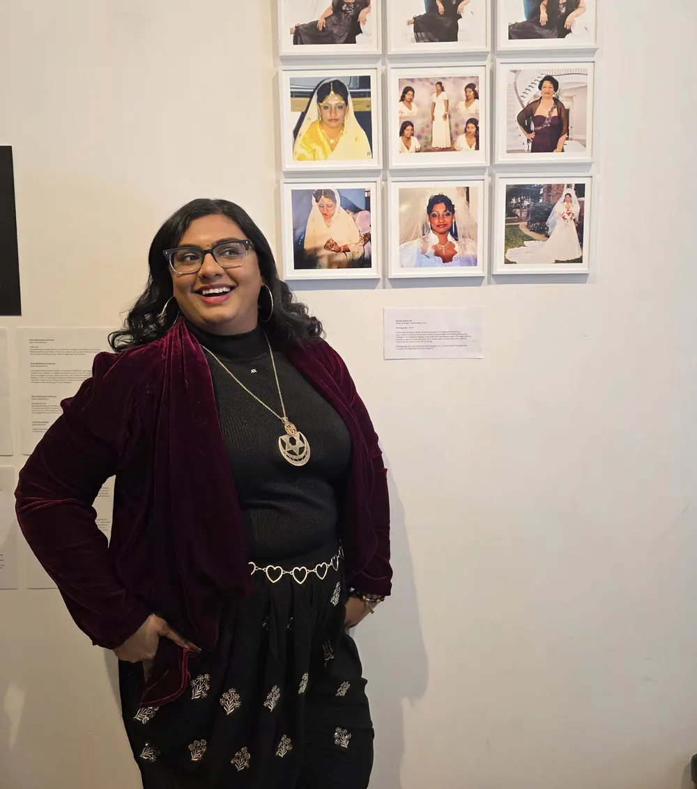 Ashley Ali smiling at a community photo exhibition